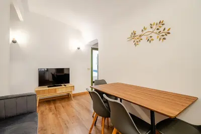 a dining room with a table and a television at Colosseo Comfort e Stile in centro a Roma in Rome
