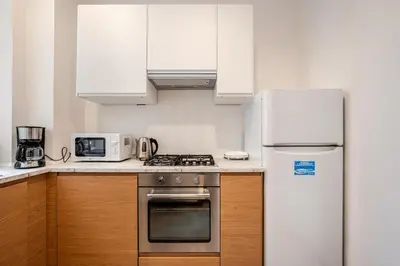 a kitchen with a refrigerator and a stove top oven at Eleganza e charme a due passi da Piazza di Spagna in Rome