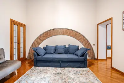 a blue couch sitting in a living room at Eleganza e charme a due passi da Piazza di Spagna in Rome