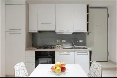 a kitchen with a table with a bowl of fruit on it at PIRAMIDE apartment in Rome