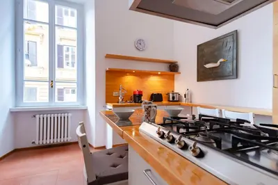 a kitchen with a stove and a counter top at Elegantis Ten windows on Trastevere in Rome