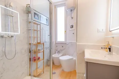 a bathroom with a shower and a toilet and a sink at Elegantis Gallo Suite Apartment - Few steps from the Vatican in Rome