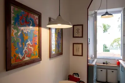 a room with a painting on the wall and a window at Elegantis Gallo Suite Apartment - Few steps from the Vatican in Rome