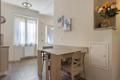 a dining room with a wooden table and chairs at Conca D'Oro Guest House - Stefania in Rome