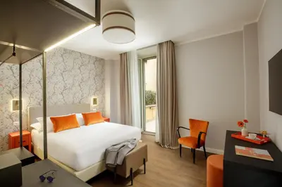 a hotel room with a bed and a desk at Urban Garden Suites in Rome