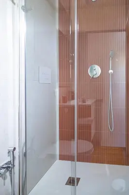 a bathroom with a shower with a toilet and a sink at Monolocale moderno a 2 min dalla metro B in Rome