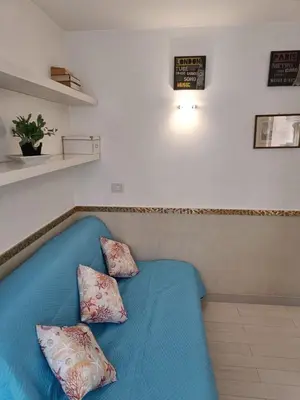 a blue couch with two pillows on it in a room at Domus Pantheon in Rome