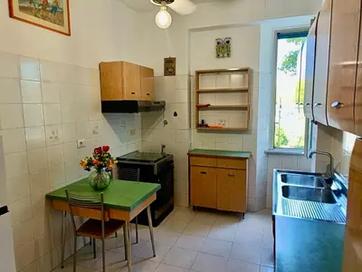 a small kitchen with a table and a sink at Flaminio Charme in Rome