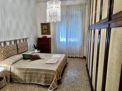 a bedroom with a bed and a chandelier at Flaminio Charme in Rome