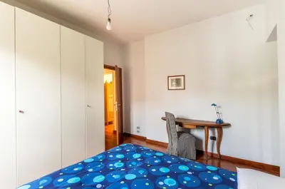 a bedroom with a bed and a desk and a table at St John Home in Rome