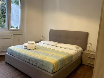 a bedroom with a bed with two towels on it at Dream Forest in Rome