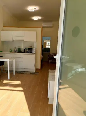 a kitchen with white cabinets and a microwave at Accommodation in Rome near Termini Loft San Lorenzo in Rome