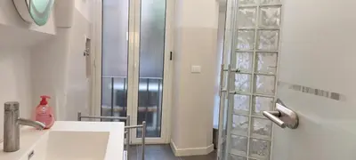 a bathroom with a shower and a white sink at Navona Cozy Apartment in Rome