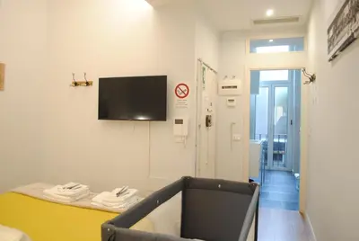 a room with a table and a tv on a wall at Navona Cozy Apartment in Rome