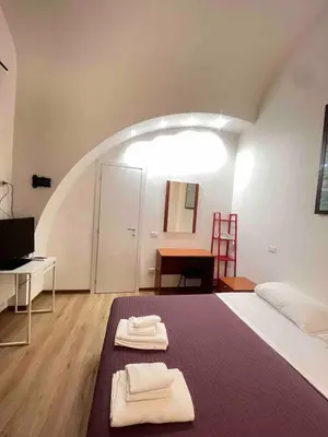 a bedroom with a bed with two towels on it at Miniapartment in the center of Rome in Rome