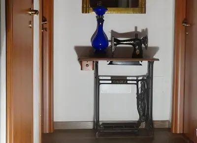 a table with a blue vase on top of it at Bed and Breakfast Adduci's House in Rome