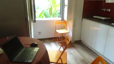 a kitchen with a table with a laptop on it at Bed and Breakfast Adduci's House in Rome