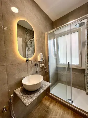a bathroom with a sink and a glass shower at Qg Golden Rooms in Rome