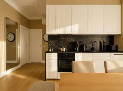 a kitchen with white cabinets and a table with chairs at ROME City Center Apartment IV in Rome