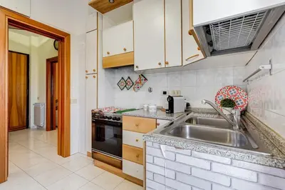 a kitchen with a sink and a stove at Karolina's Home, 2-BDR at Vatican in Rome