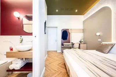 a small bathroom with a bed and a sink at Bea Boutique Hotel in Rome
