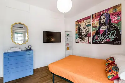 a bedroom with a bed and a blue dresser at Lungotevere Bijou with Private Balcony in Rome