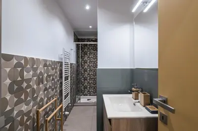 a bathroom with a sink and a shower at Lungotevere Bijou with Private Balcony in Rome