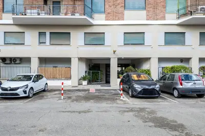 three cars parked in a parking lot in front of a building at Lungotevere Bijou with Private Balcony in Rome