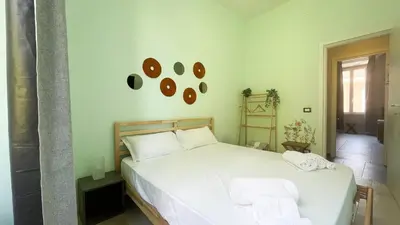 a bedroom with a white bed with towels on it at La casa dell'artista in Rome