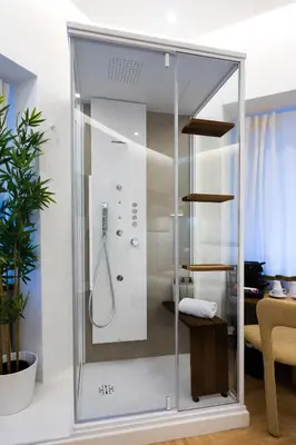 a glass shower stall in a living room at Barberini Design Suites in Rome