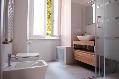a bathroom with a toilet and a sink and a window at VG Apartment - Re di Roma in Rome