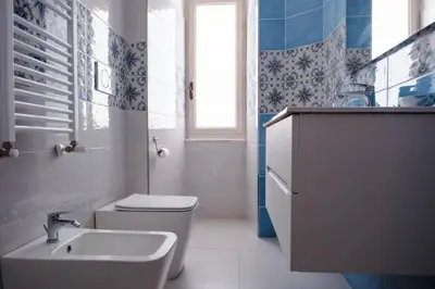 a bathroom with a toilet and a sink at VG Apartment - Re di Roma in Rome
