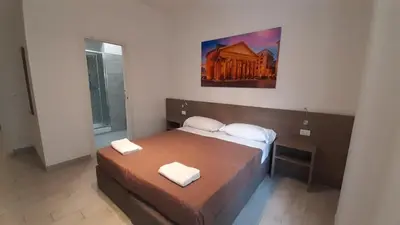 a bedroom with a bed with two towels on it at Vatican Rooms Cipro 2 in Rome