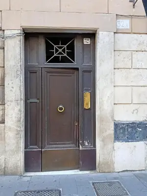 a large brown door on a building at Roman Babuino Inn in Rome