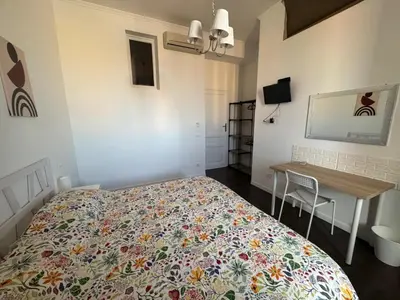 a small bedroom with a bed and a desk at La Casa di Bru - Cinque Camere - Dieci posti - Terrazzo in Rome