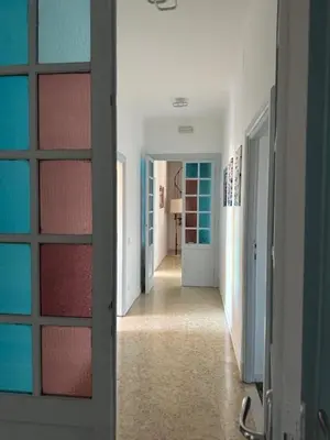 a hallway with a door leading into a room at La Casa di Bru - Cinque Camere - Dieci posti - Terrazzo in Rome