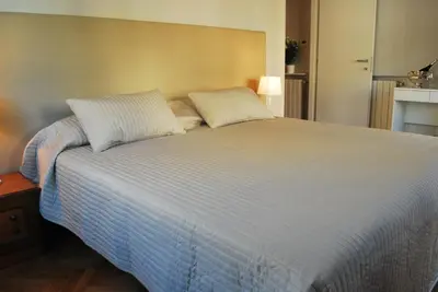 a large bed with two pillows on top of it at Attico 203 in Rome