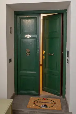 a green door with a box in front of it at Dimora Conti in Rome
