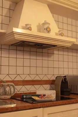 a kitchen with a counter top with dishes on a shelf at Dimora Conti in Rome