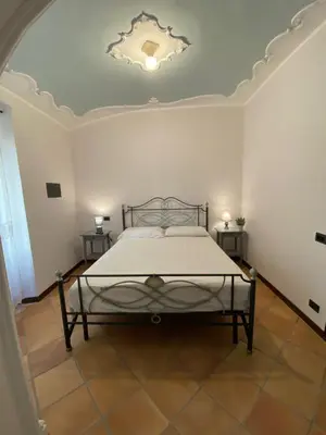 a bedroom with a bed in a room with a ceiling at Dimora Conti in Rome