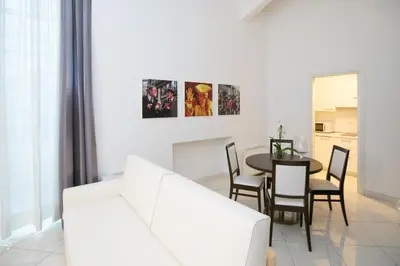 a living room with a white couch and a table at Morin 10 Rome Exclusive Suites in Rome