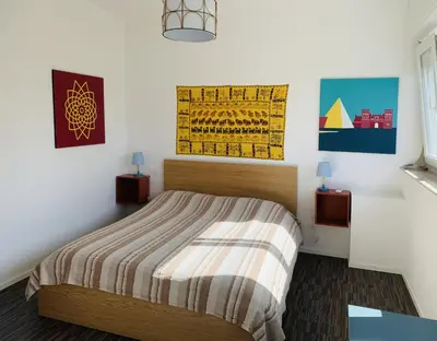 a bedroom with a bed and paintings on the wall at Apartment SIX Rome Flaminio - Villaggio Olimpico in Rome