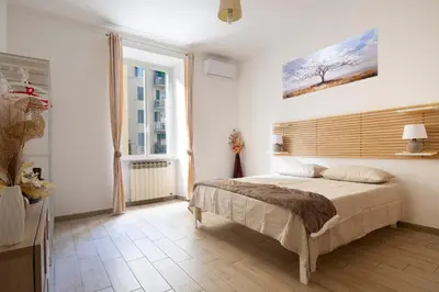 a bedroom with a bed and a painting on the wall at Holiday Season in Rome