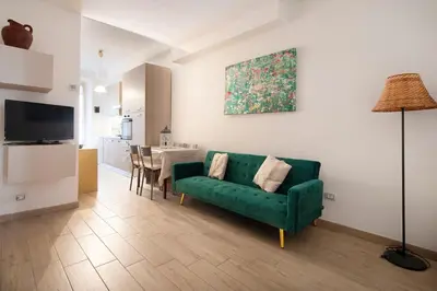 a living room with a green couch and a table at Holiday Season in Rome