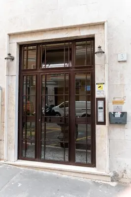 a building with glass doors on the side of it at Apartment Casa Girina Boutique in Rome