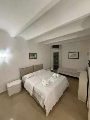 a bedroom with a large bed with white sheets at Family Entire House in Rome