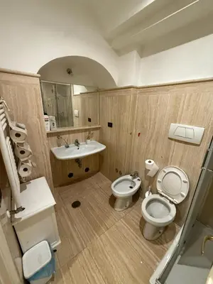 a bathroom with two toilets and a sink at Family Entire House in Rome