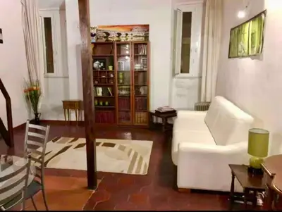 a living room with a white couch and a table at Nice apartment in the historic center in Rome