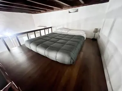 a large bed in a room with a wooden floor at Nice apartment in the historic center in Rome