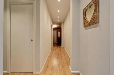 a hallway with white walls and a mirror on the wall at Design Monteverde Flat Jenner 70 in Rome